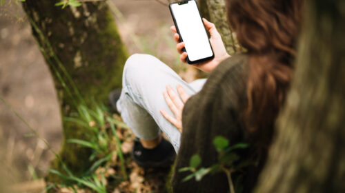 une femme sur son téléphone en foret